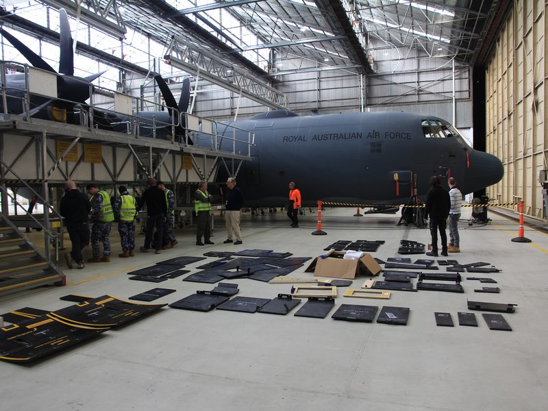 RAAF C-130J Hercules in a hangar with AMCE armour panels laid out for installation